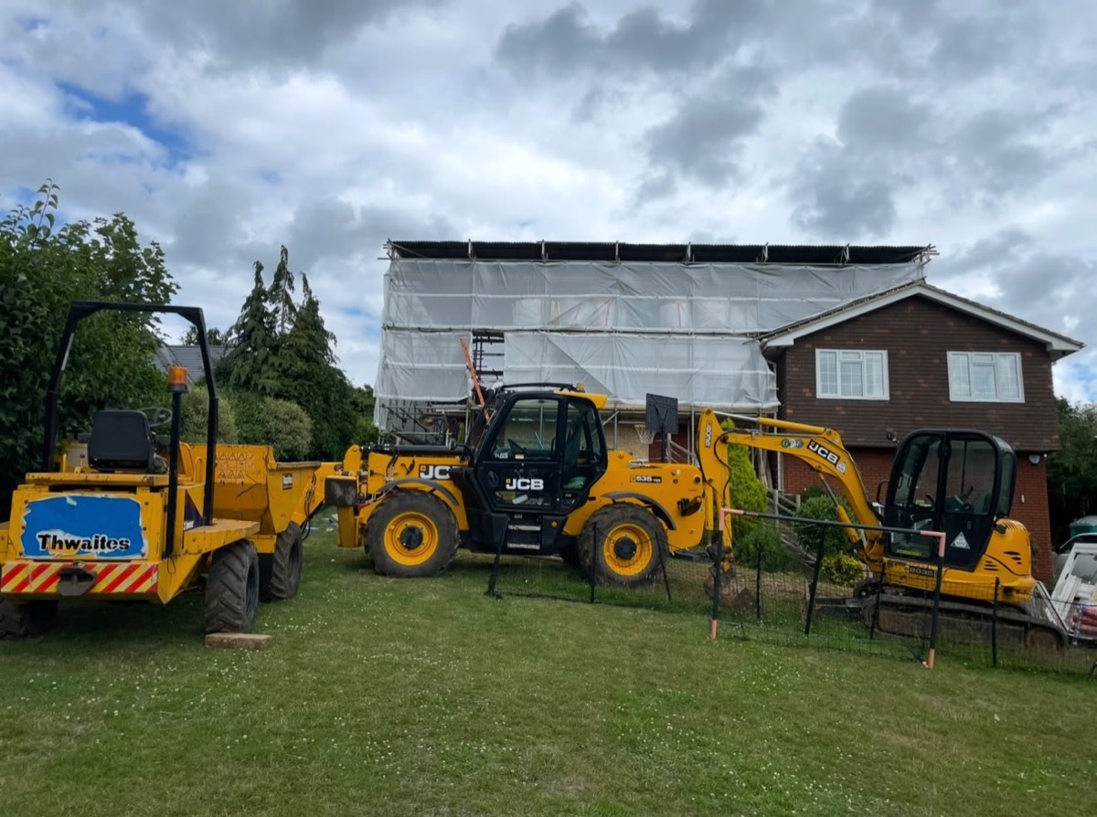Scaffolded house with temporary roof and plant on site near Milton Keynes